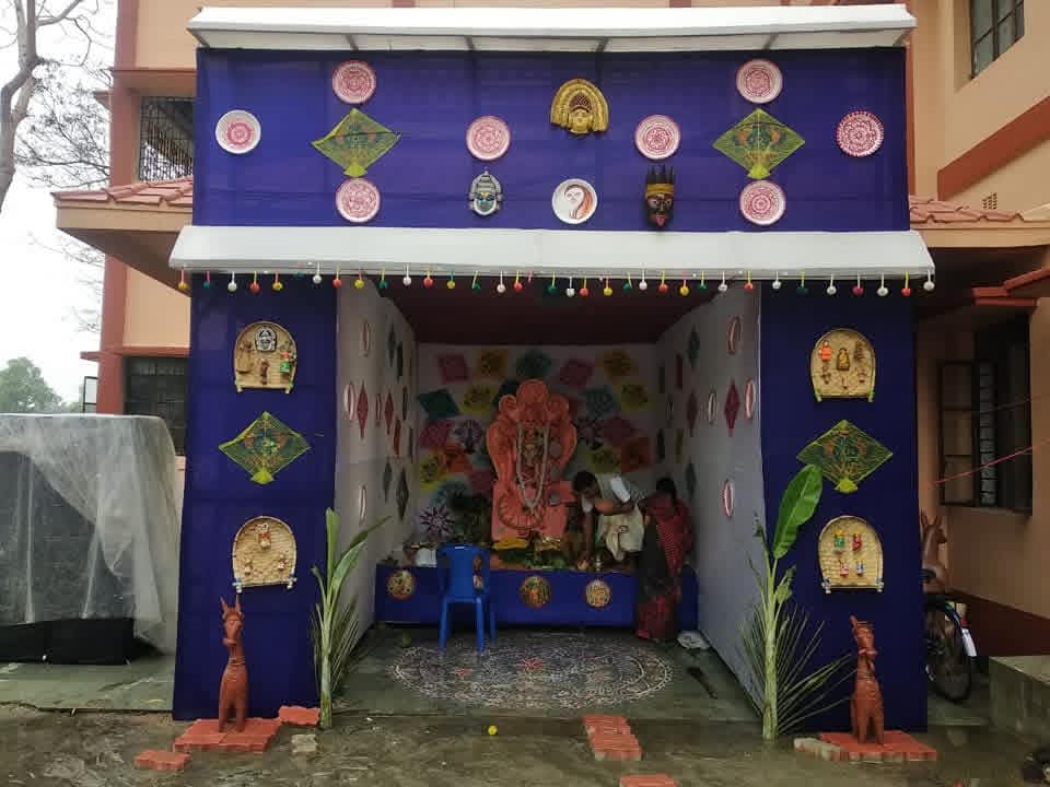 Blue and white decorated Saraswati Puja pandal entrance with festive kite artwork