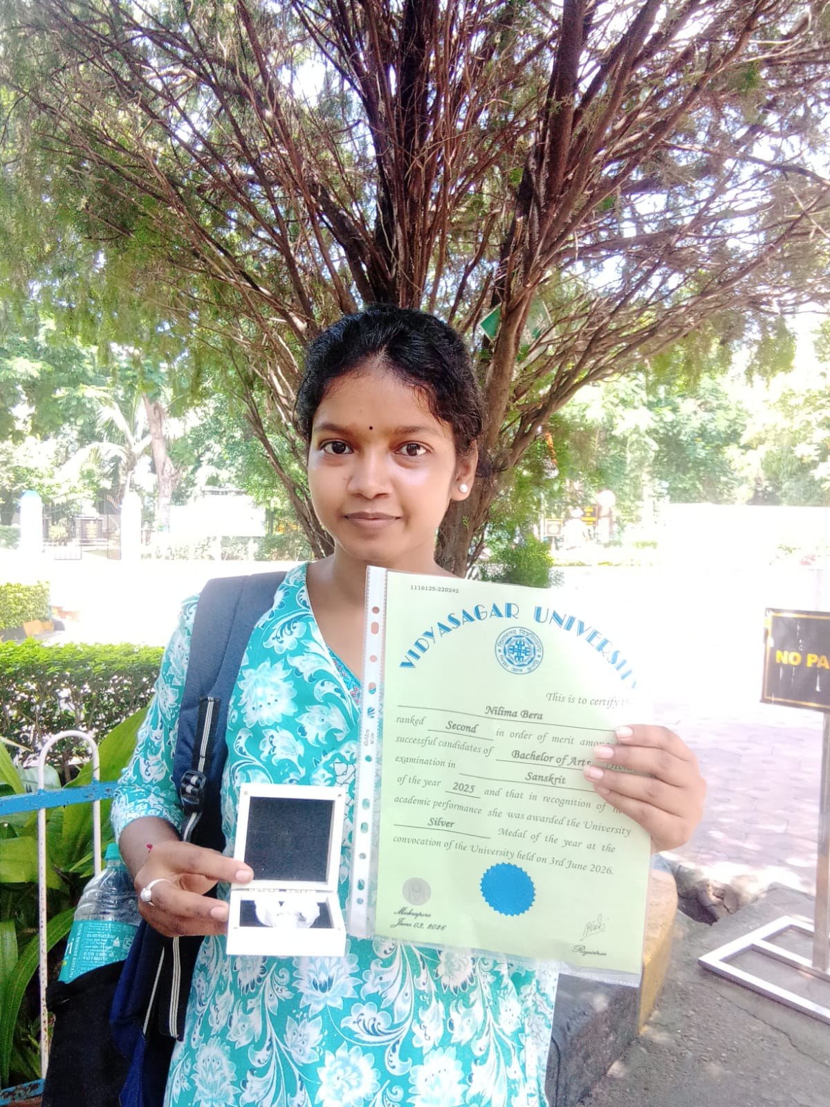 Nilima Bera, Dept. of Sanskrit, displaying her Vidyasagar University Silver Medal certificate