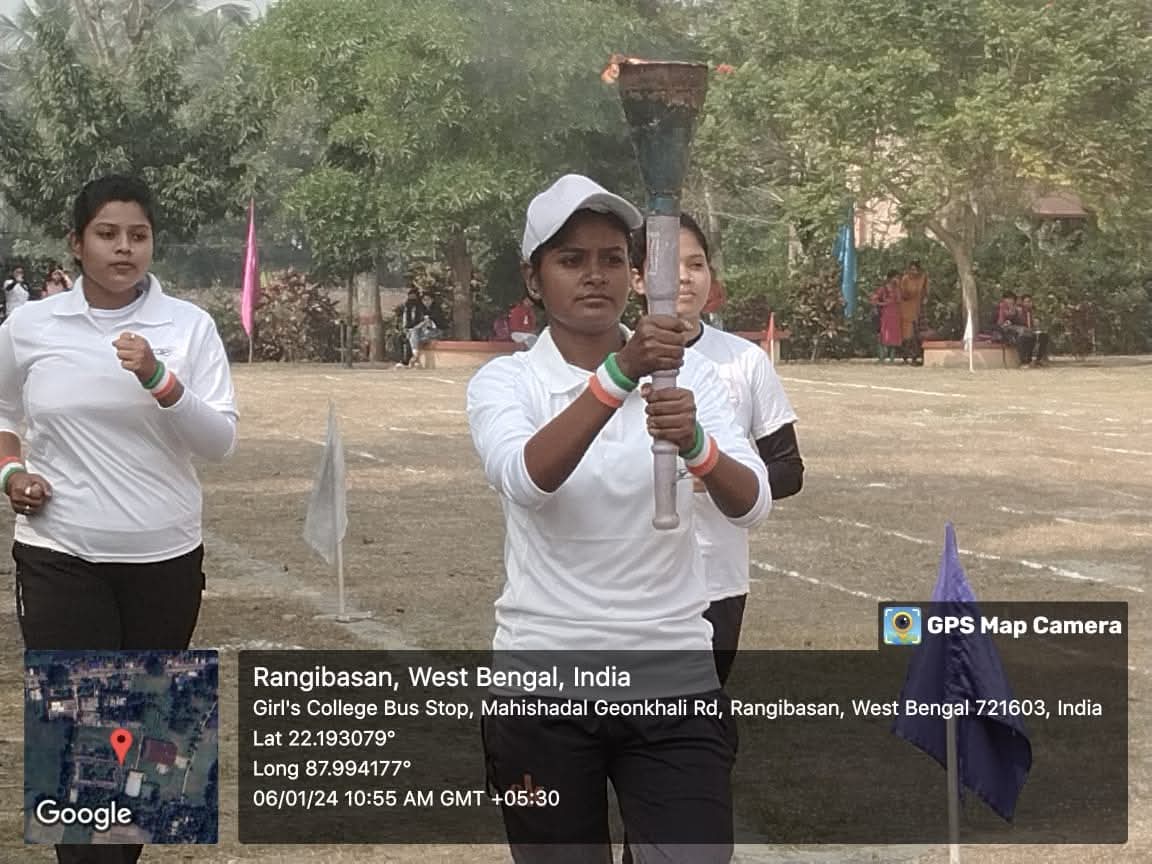 Student carrying the torch during the sports meet, with teammates alongside