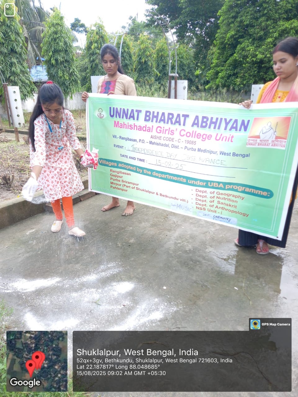 UBA volunteer holding the Unnat Bharat Abhiyan banner while preparing the venue