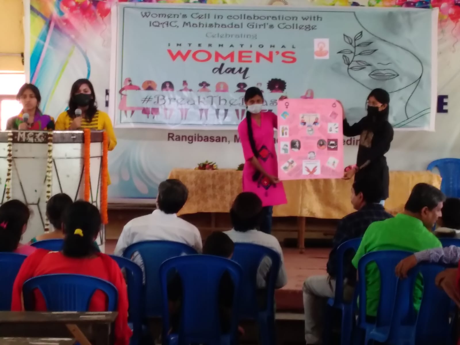 Students presenting a poster on gender awareness during International Women's Day celebrations